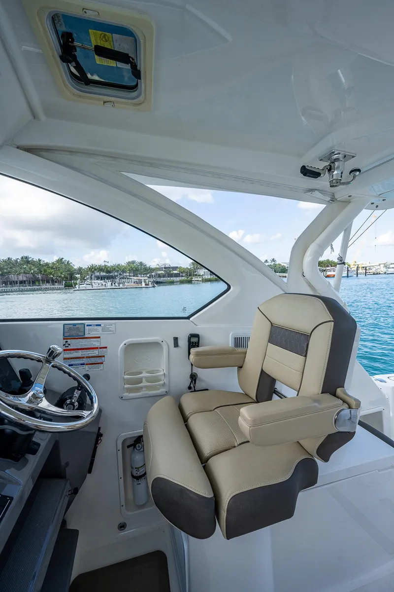 Slide: The Image of Captain's chair on 2020 Pursuit OS 355 boat with ocean view. - 27