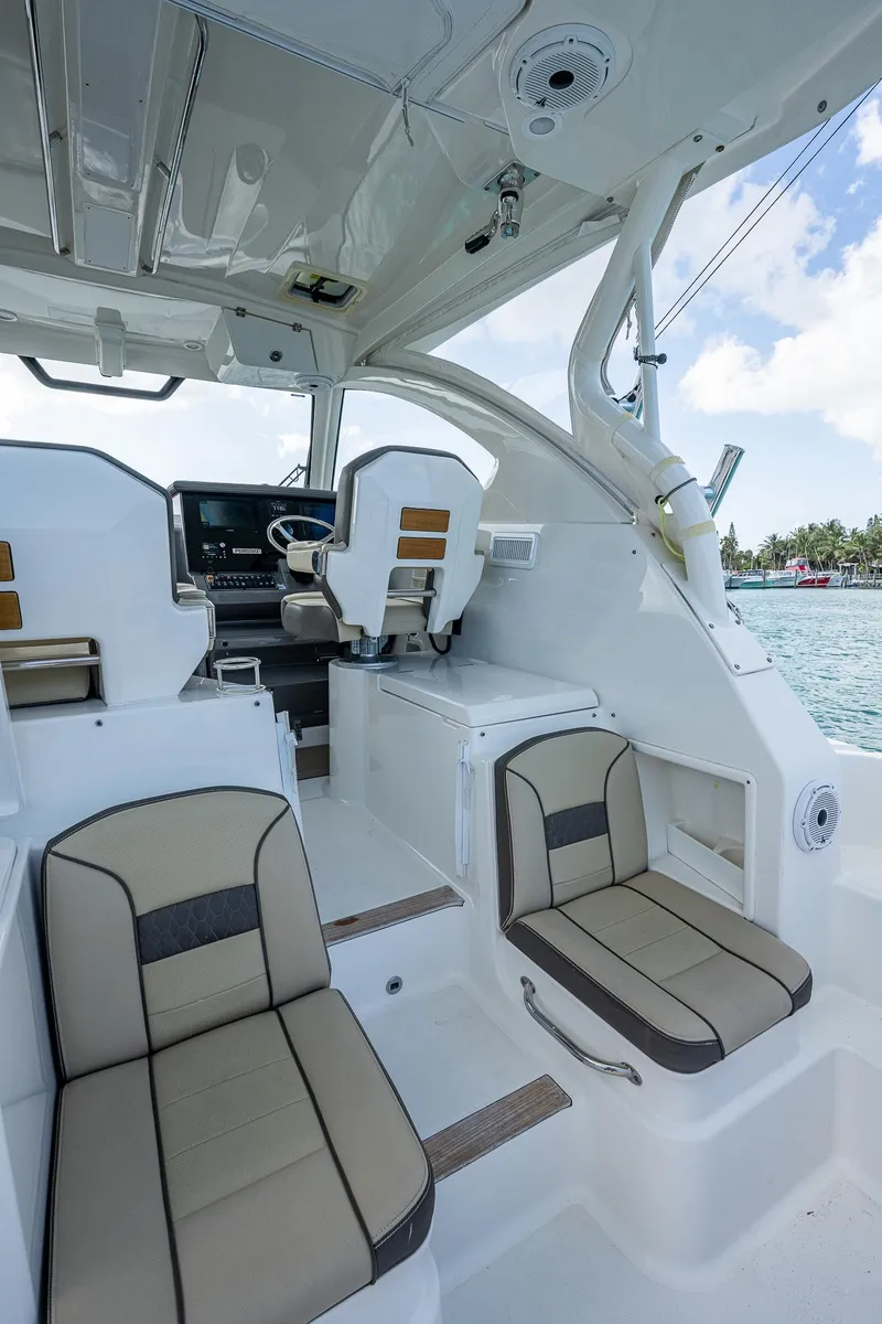Slide: The Image of 2020 Pursuit OS 355 boat interior with seating and helm station. - 31