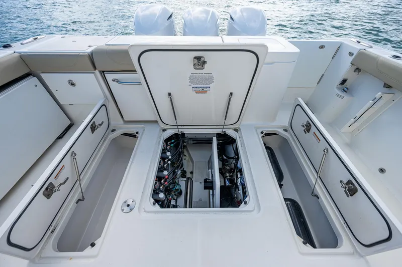 Slide: The Image of 2020 Pursuit OS 355 boat engine compartment and storage areas. - 38
