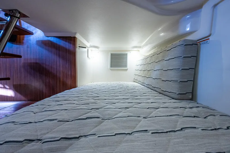 Slide: The Image of 2020 Pursuit OS 355 cabin interior with bed and lighting. - 48