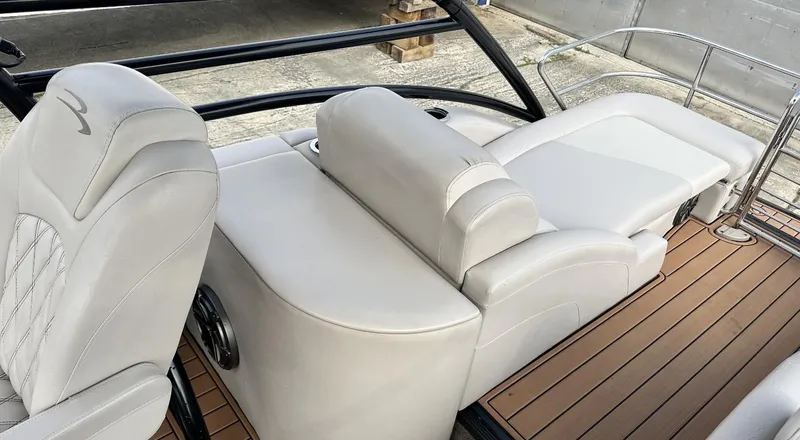 Slide: The Image of 2014 Bennington 2550 QSR boat interior with white leather seats and wooden deck. - 11