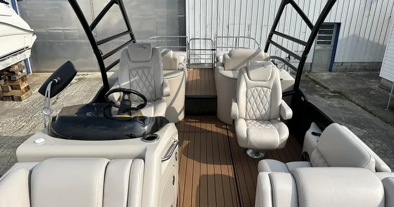 Slide: The Image of 2014 Bennington 2550 QSR pontoon boat with luxurious seating and modern helm station. - 12