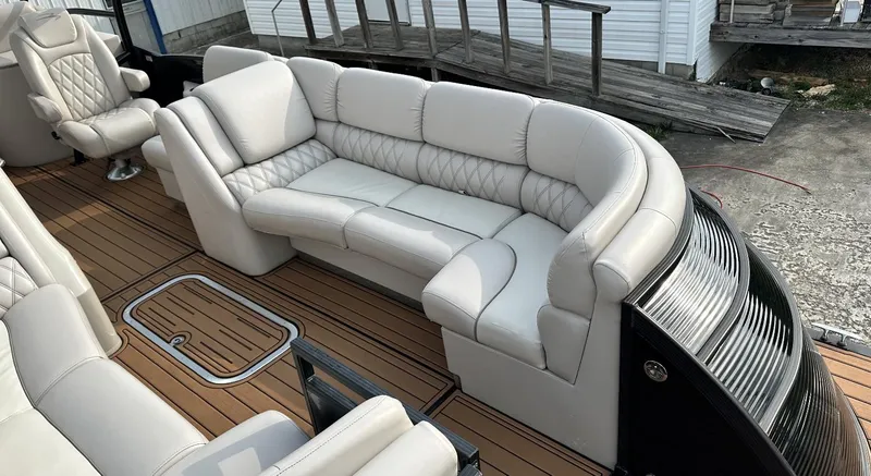 Slide: The Image of 2014 Bennington 2550 QSR boat interior with luxurious beige seating and wooden flooring. - 15