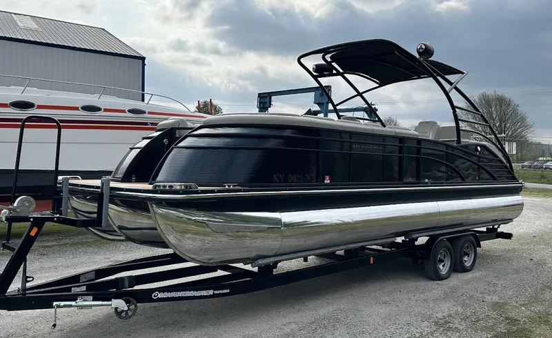Slide: The Image of 2014 Bennington 2550 QSR pontoon boat on a trailer, parked outdoors. - 5