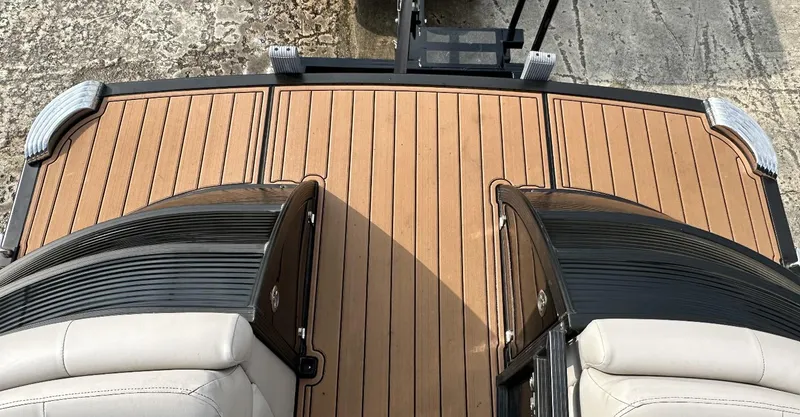Slide: The Image of 2014 Bennington 2550 QSR boat deck with teak flooring and cushioned seating. - 8