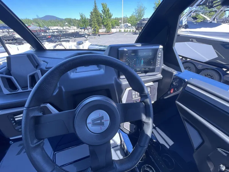 Slide: The Image of 2024 Axis T250 boat dashboard with steering wheel and digital display. - 12