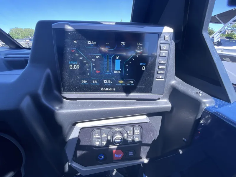 Slide: The Image of 2024 Axis T250 dashboard with Garmin display showing speed, RPM, and fuel data. - 13
