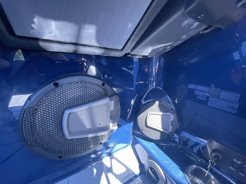 Slide: The Image of 2024 Axis T250 interior with sleek blue design and integrated speaker system. - 15
