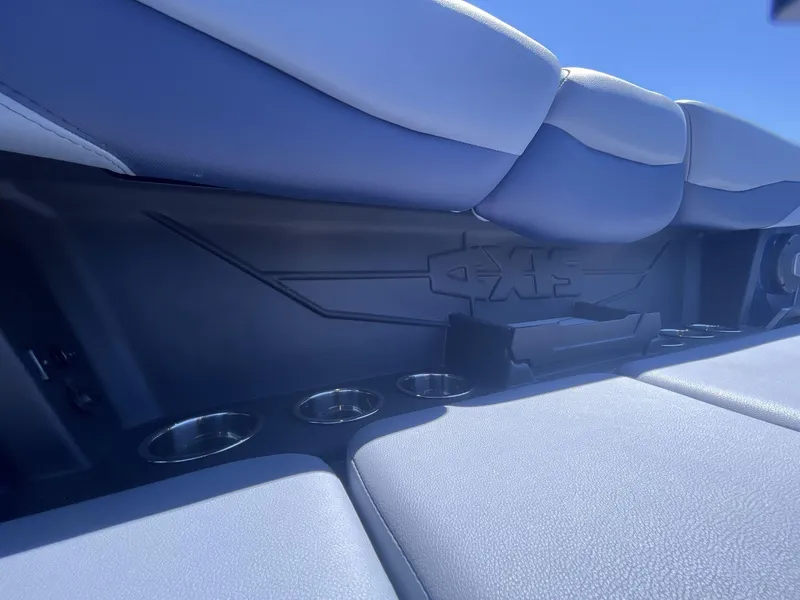 Slide: The Image of 2024 Axis T250 boat interior with cushioned seating and integrated cup holders. - 17