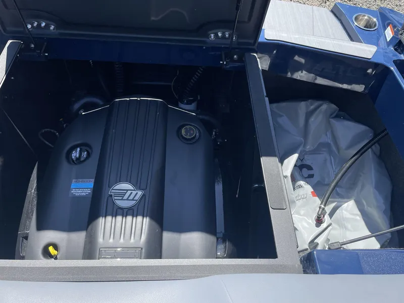 Slide: The Image of 2024 Axis T250 engine compartment with visible components and storage area. - 19