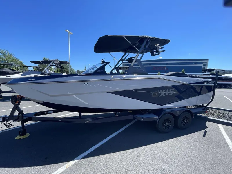 Slide: The Image of 2024 Axis T250 boat on trailer in parking lot under clear blue sky. - 5