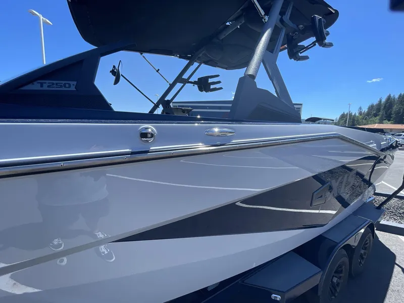 Slide: The Image of 2024 Axis T250 boat in a parking lot, showcasing sleek design and modern features. - 6