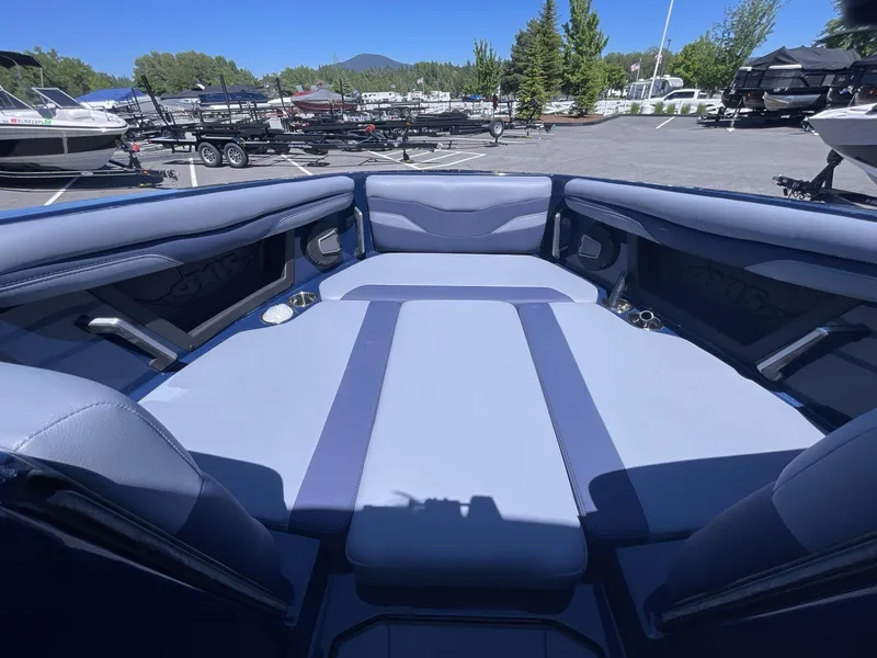 Slide: The Image of 2024 Axis T250 boat interior with spacious seating in a marina setting. - 8