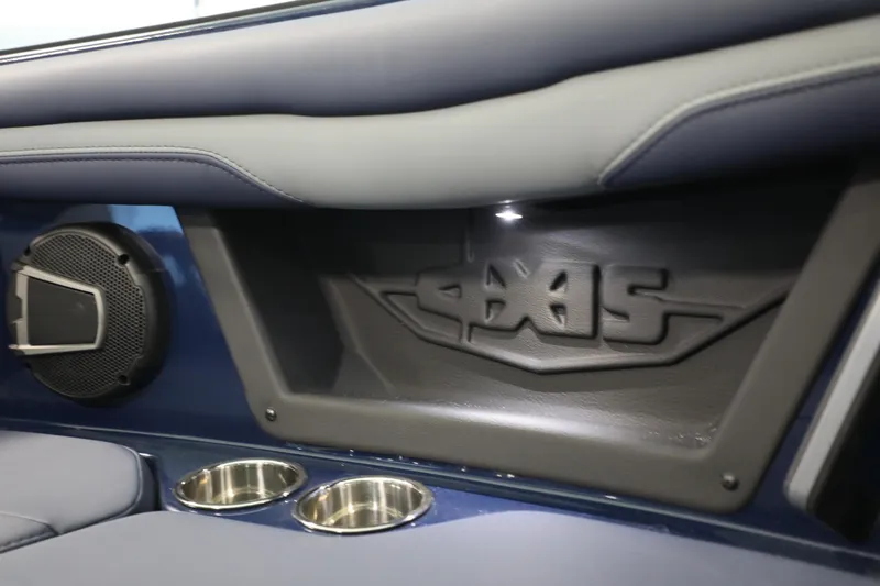 Slide: The Image of 2024 Axis T250 interior detail with speaker and cup holders. - 10