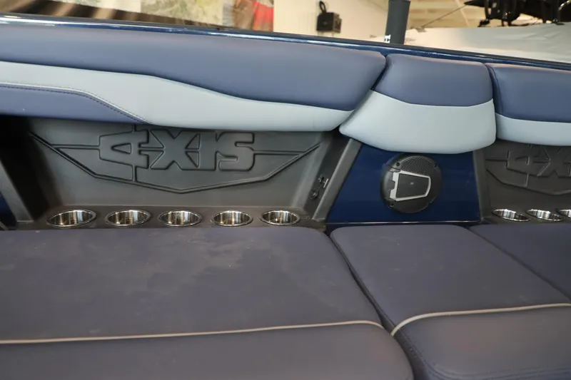Slide: The Image of 2024 Axis T250 boat interior with cushioned seating and built-in cup holders. - 11