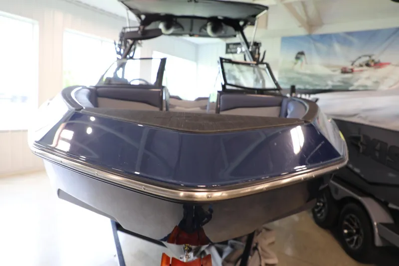 Slide: The Image of 2024 Axis T250 boat in showroom, sleek design, blue exterior, modern features. - 3