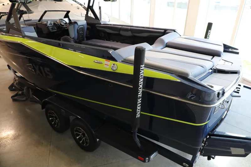 Slide: The Image of 2024 Axis T250 boat with sleek design and spacious seating, showcased indoors. - 5