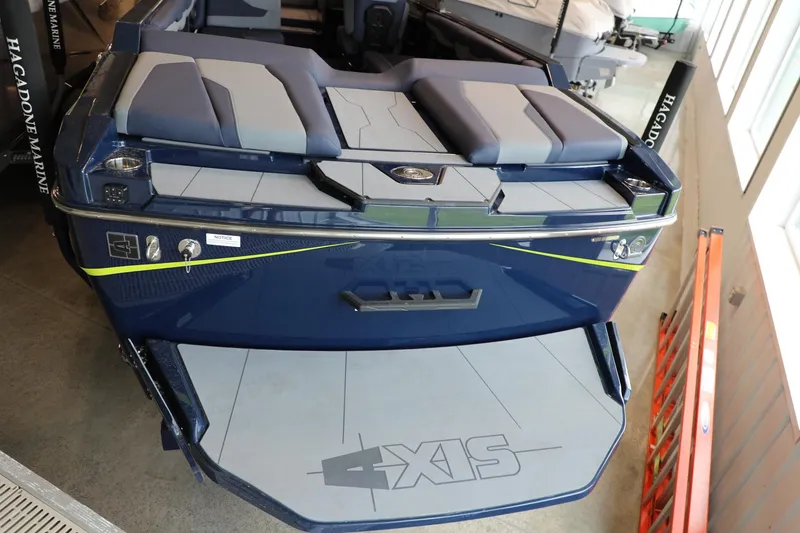 Slide: The Image of 2024 Axis T250 boat with sleek design and comfortable seating in showroom. - 6