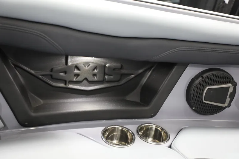 Slide: The Image of 2024 Axis T250 interior detail with speaker and cup holders. - 13