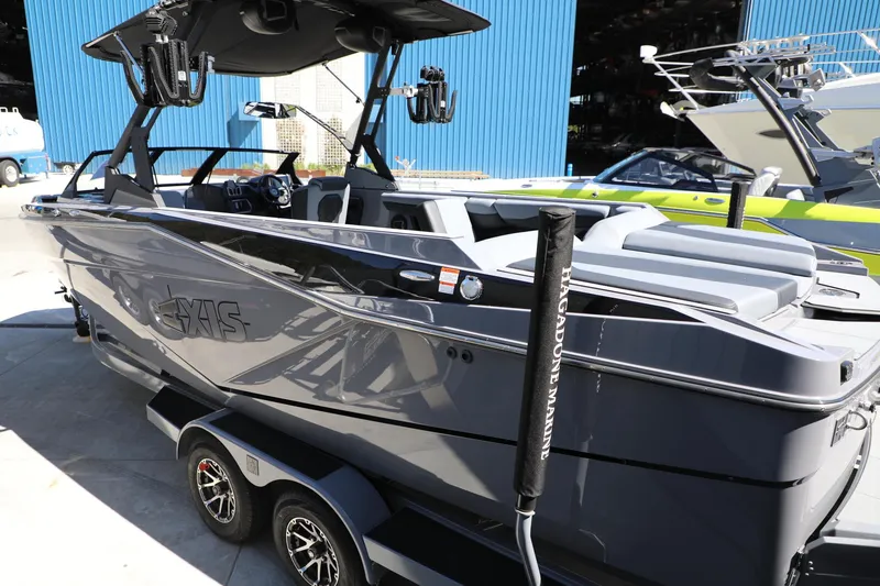 Slide: The Image of 2024 Axis T250 boat in a marina, sleek design, gray color, on a trailer. - 4