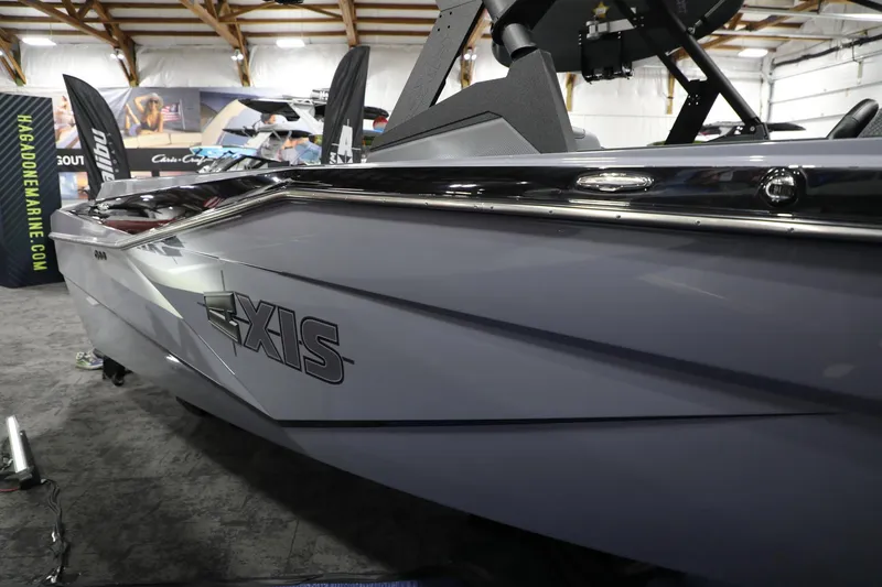 Slide: The Image of 2024 Axis T250 boat displayed indoors, showcasing sleek design and branding. - 6