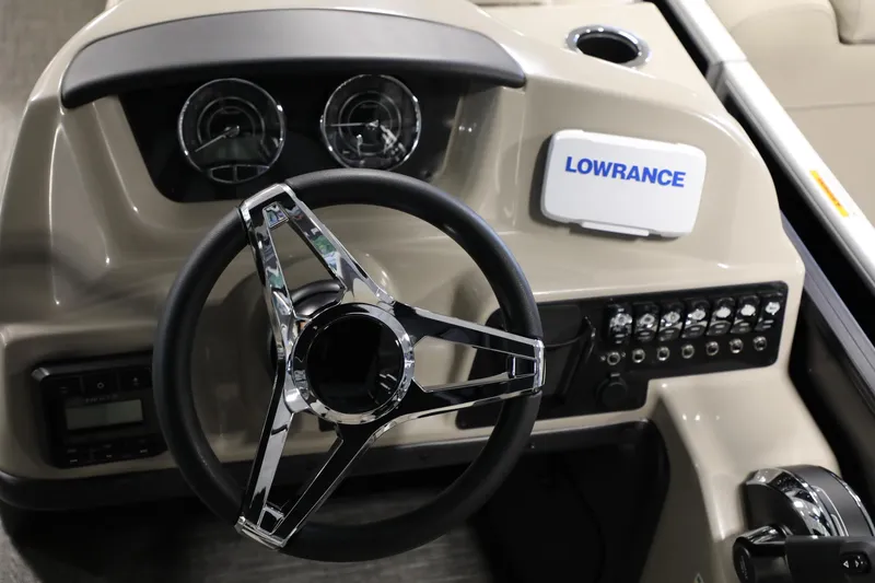 Slide: The Image of 2024 Barletta ARIA A20QC boat dashboard with steering wheel and Lowrance system. - 13