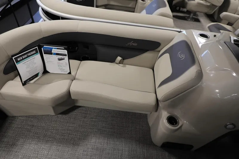Slide: The Image of 2024 Barletta ARIA A20QC boat interior with beige seating and informational brochures. - 9