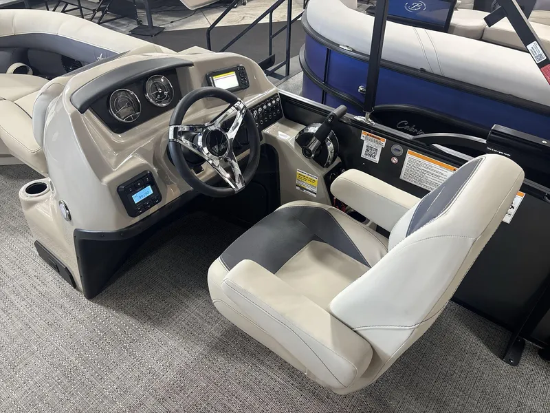 Slide: The Image of 2024 Barletta ARIA 20UC boat interior with steering wheel and dashboard controls. - 11
