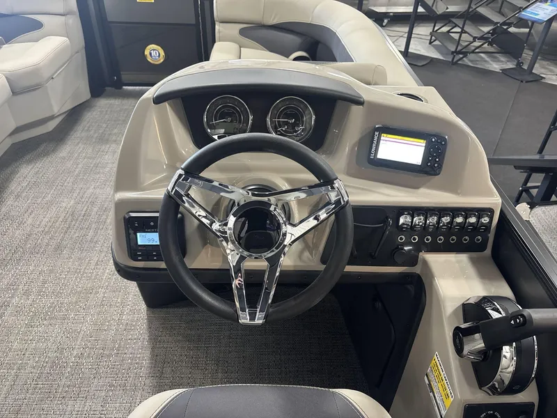 Slide: The Image of 2024 Barletta ARIA 20UC boat dashboard with steering wheel and control panel. - 12