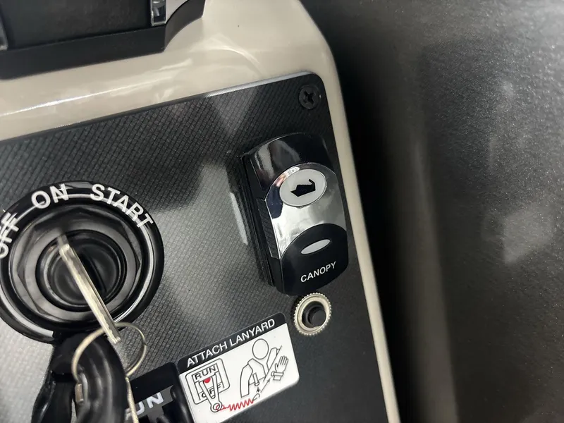 Slide: The Image of 2024 Barletta ARIA 20UC ignition and canopy control panel with key and lanyard attachment. - 16