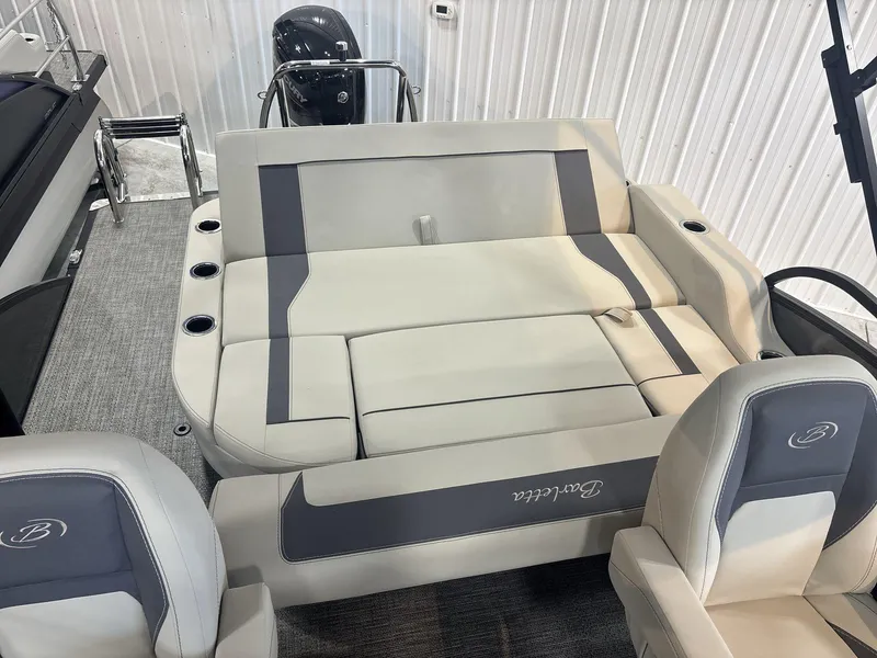 Slide: The Image of 2024 Barletta ARIA 20UC boat interior with plush seating and cup holders. - 20