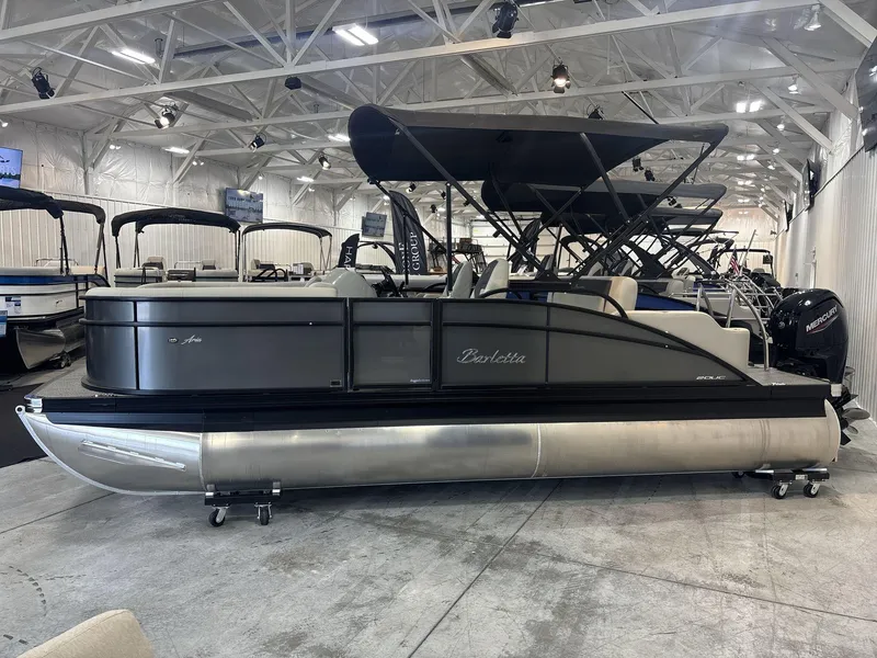 Slide: The Image of 2024 Barletta ARIA 20UC pontoon boat displayed in a showroom with other boats. - 3
