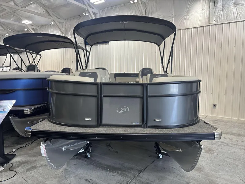 Slide: The Image of 2024 Barletta ARIA 20UC pontoon boat displayed indoors, featuring sleek design and canopy. - 4