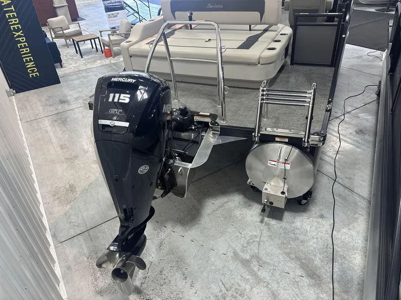 Slide: The Image of 2024 Barletta ARIA 20UC pontoon boat with Mercury 115 outboard motor displayed indoors. - 5