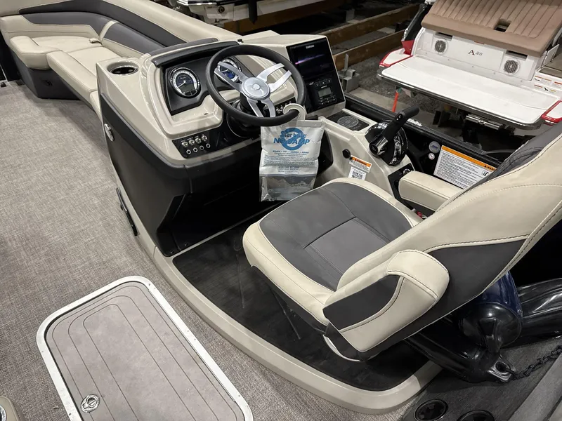 Slide: The Image of 2023 Barletta C24CC boat interior with steering console and seating. - 11