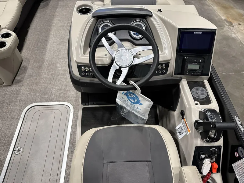 Slide: The Image of 2023 Barletta C24CC boat dashboard with steering wheel and control panel. - 13