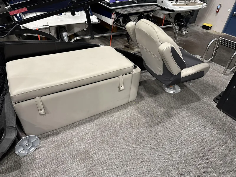 Slide: The Image of 2023 Barletta C24CC boat interior with cushioned seating and storage. - 15