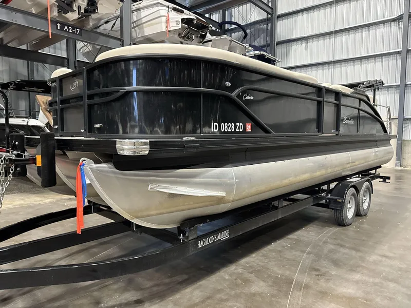 Slide: The Image of 2023 Barletta C24CC pontoon boat on trailer in storage facility. - 3