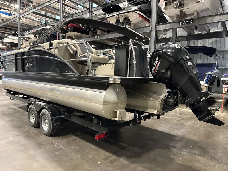 Slide: The Image of 2023 Barletta C24CC pontoon boat on trailer in storage facility. - 7