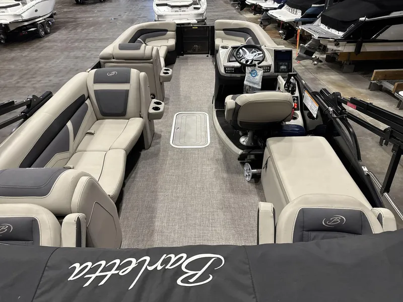 Slide: The Image of 2023 Barletta C24CC pontoon boat interior with luxurious seating and modern dashboard. - 8