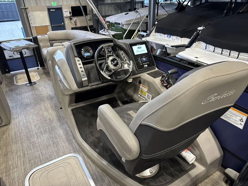 Slide: The Image of 2023 Barletta Lusso 25MA boat interior with modern helm and seating. - 10