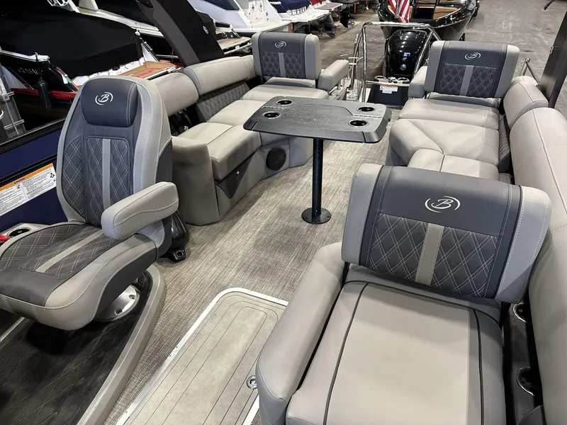 Slide: The Image of Luxurious 2023 Barletta Lusso 25MA pontoon boat interior with plush seating and table. - 13