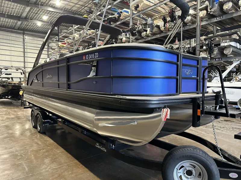 Slide: The Image of 2023 Barletta Lusso 25MA pontoon boat in a showroom on a trailer. - 3