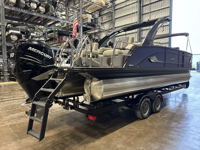 Slide: The Image of 2023 Barletta Lusso 25MA pontoon boat with Mercury engine in a warehouse setting. - 4