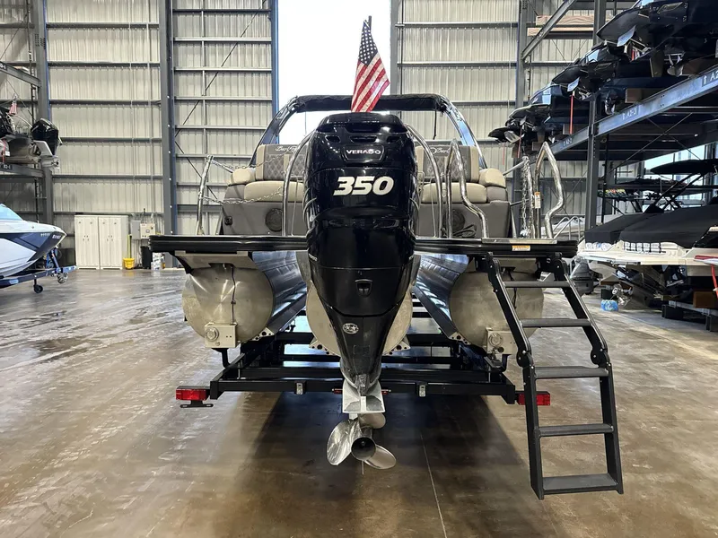 Slide: The Image of 2023 Barletta Lusso 25MA pontoon boat with 350 horsepower engine in a storage facility. - 5