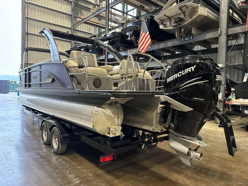 Slide: The Image of 2023 Barletta Lusso 25MA pontoon boat with Mercury engine in a storage facility. - 6