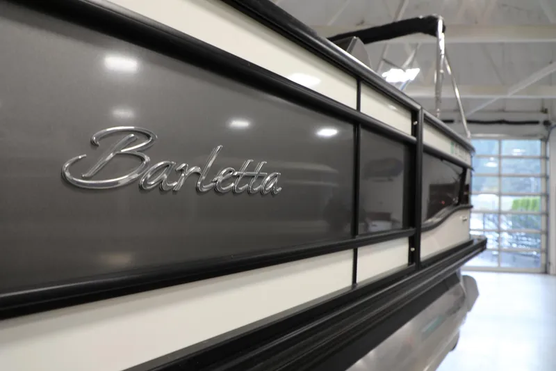 Slide: The Image of 2023 Barletta L25UEA pontoon boat in showroom, close-up of logo. - 15