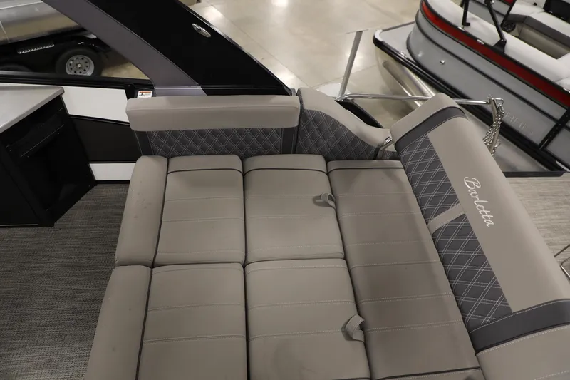 Slide: The Image of 2023 Barletta L25UEA pontoon boat interior with gray cushioned seating. - 19