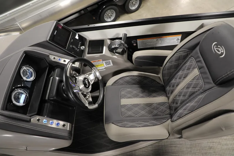 Slide: The Image of 2023 Barletta L25UEA boat cockpit with luxury seating and modern dashboard controls. - 22