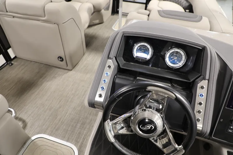 Slide: The Image of 2023 Barletta L25UEA boat interior with steering wheel and dashboard controls. - 23